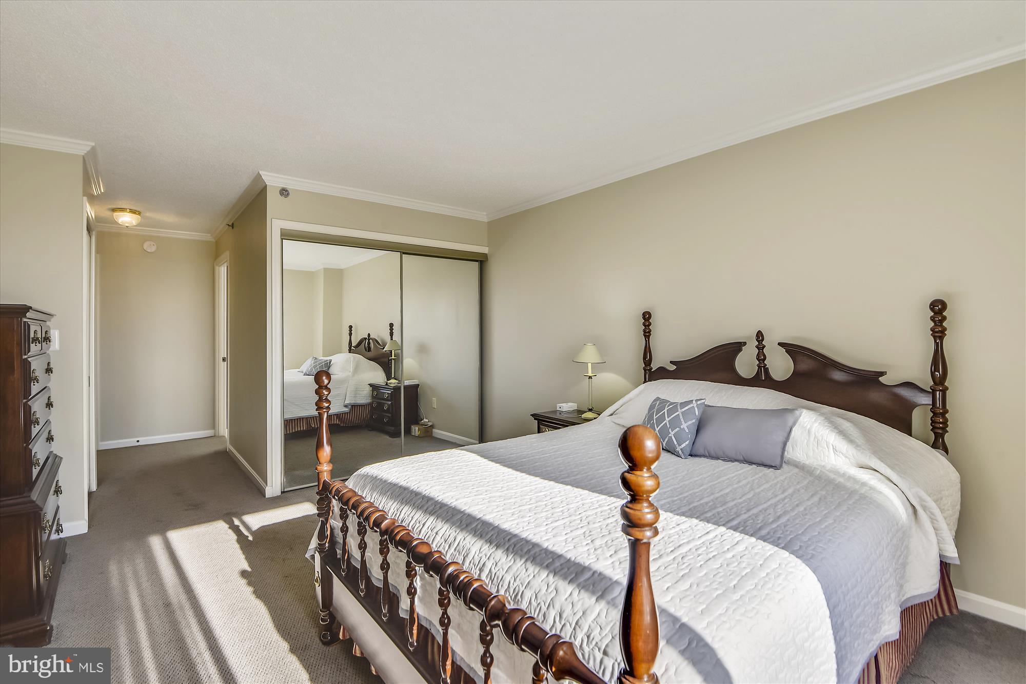 19385 Cypress Ridge Terrace, Unit 920 Leesburg, VA 20176 - Photo 12 of 42 a bedroom with a bed and wooden floor