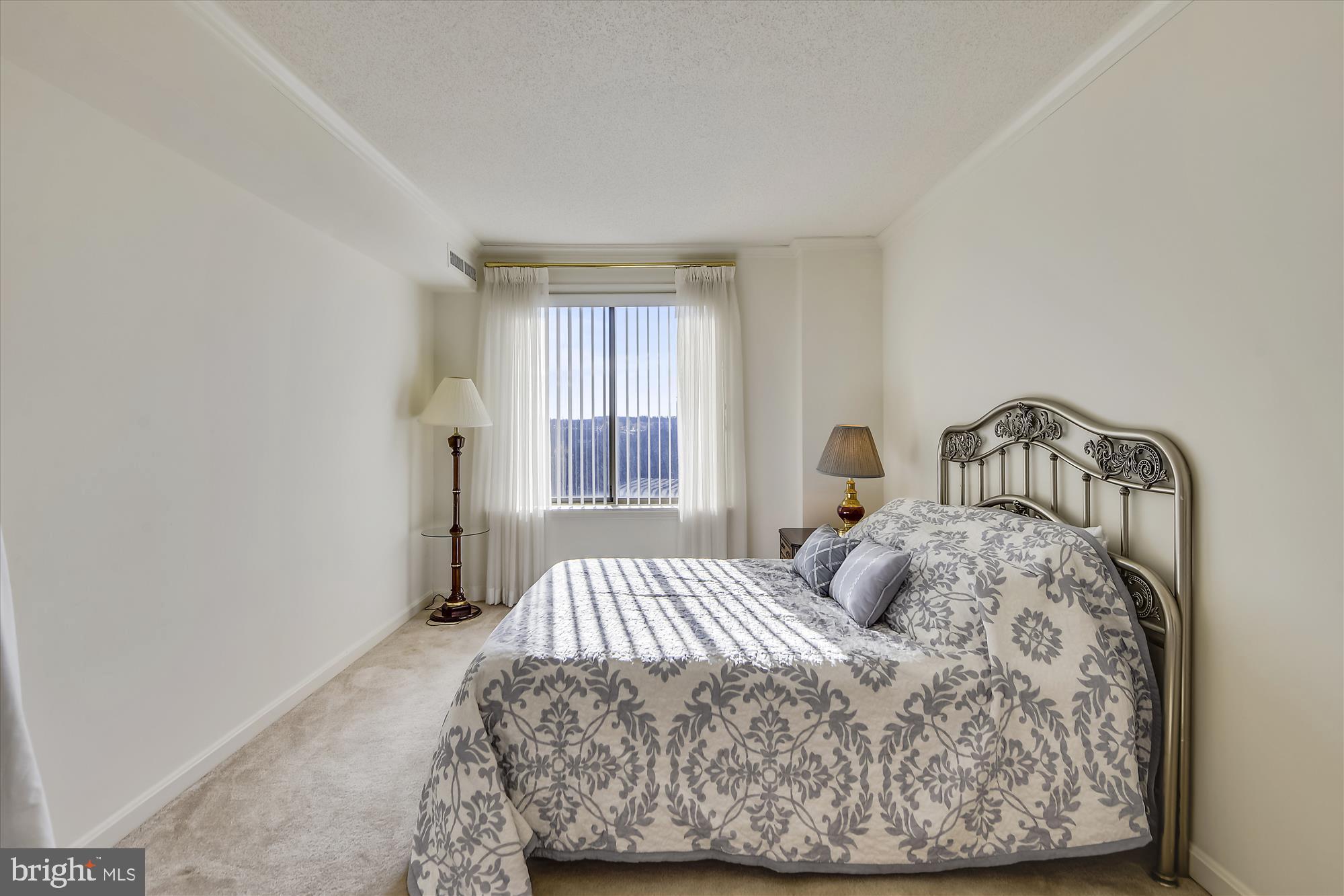 19385 Cypress Ridge Terrace, Unit 920 Leesburg, VA 20176 - Photo 17 of 42 a bedroom with a bed and window