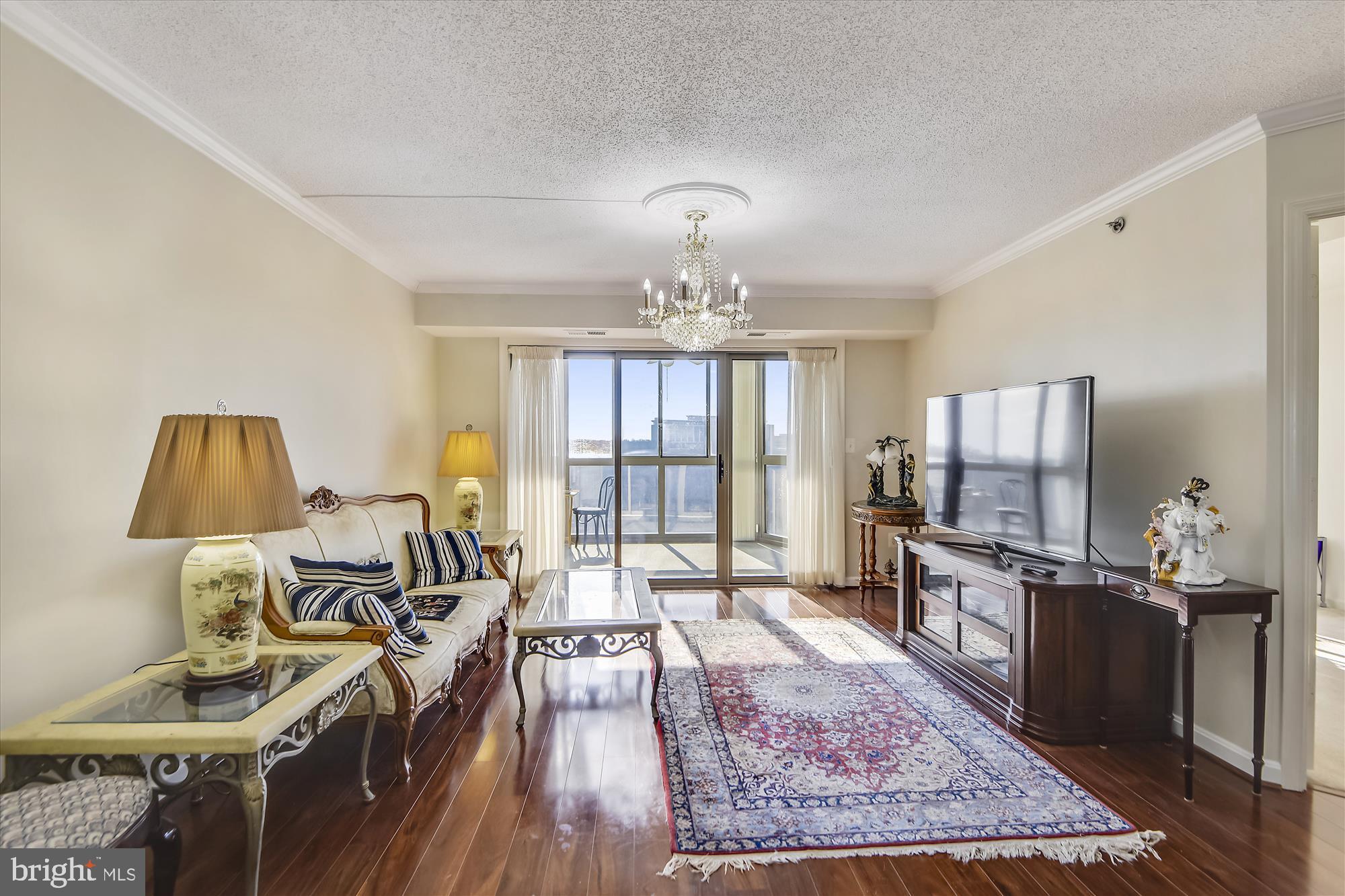 19385 Cypress Ridge Terrace, Unit 920 Leesburg, VA 20176 - Photo 3 of 42 a living room with furniture a rug and a chandelier