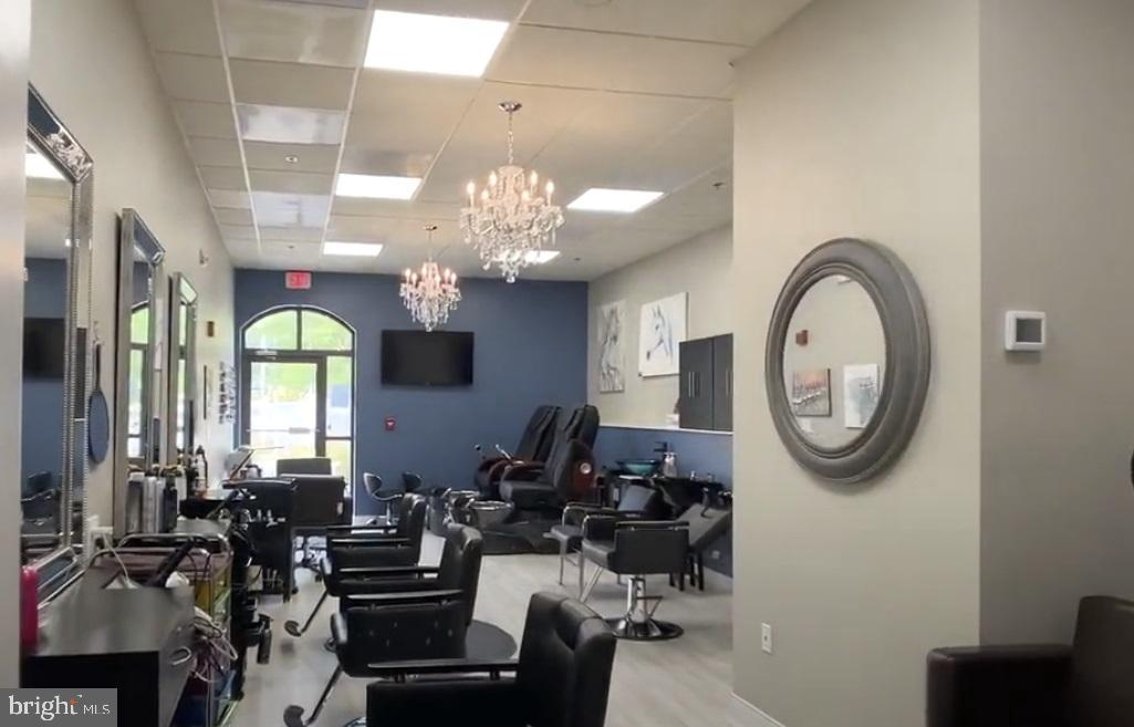 19385 Cypress Ridge Terrace, Unit 920 Leesburg, VA 20176 - Photo 40 of 42 a very nice looking dining room with a large mirror and a fan