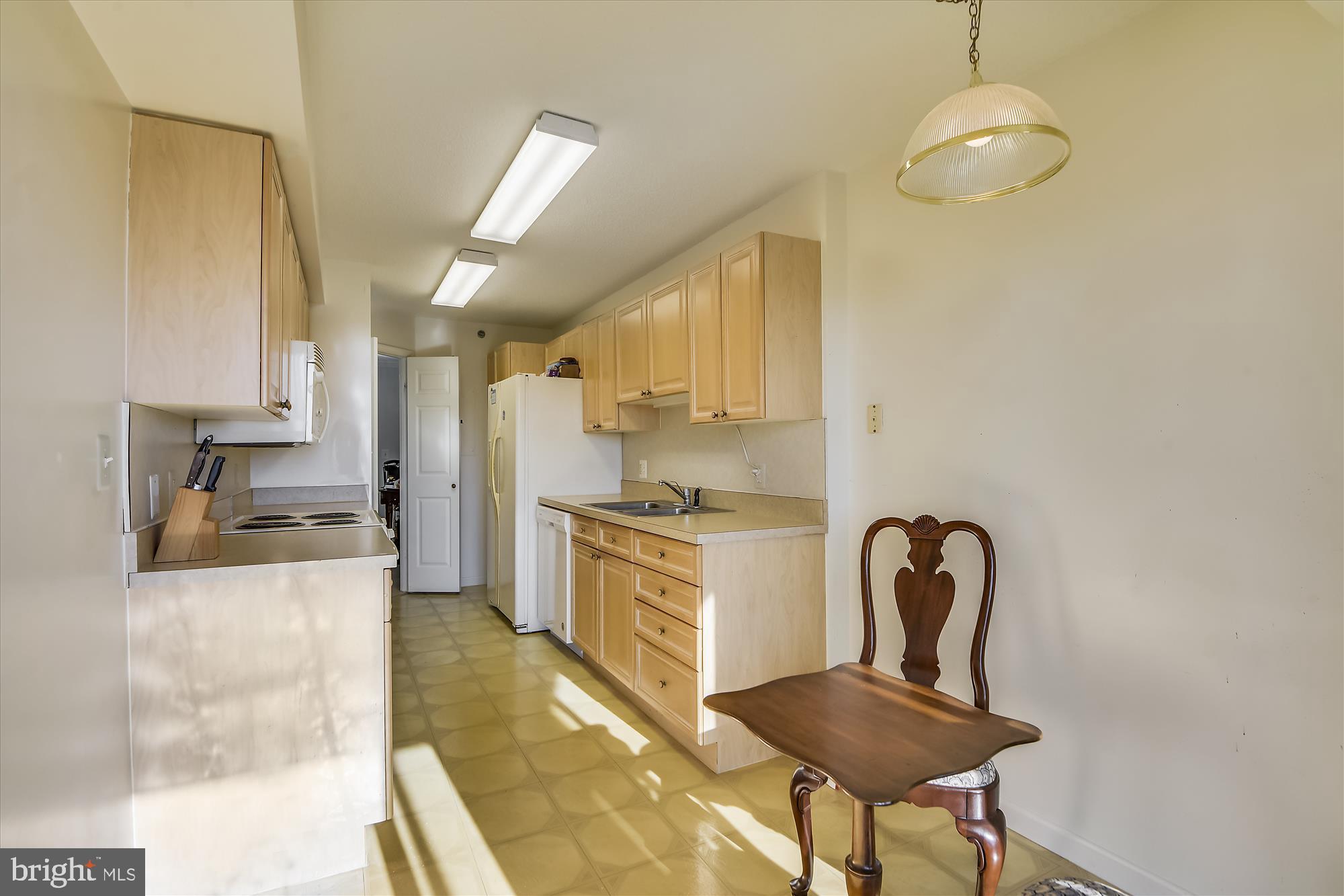 19385 Cypress Ridge Terrace, Unit 920 Leesburg, VA 20176 - Photo 10 of 42 a kitchen with stainless steel appliances granite countertop a stove a refrigerator a sink dishwasher with a dining table and chair