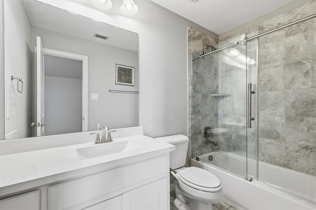 1933 Snapdragon Road Frisco, TX 75033 - Photo 35 of 40 Bathroom featuring a white vanity with integrated sink, chrome faucet, and a large wall mirror