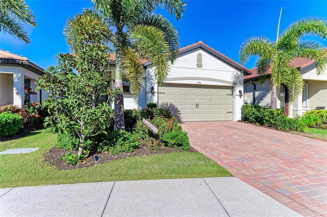 a kitchen with stainless steel appliances a white refrigerator a sink a stove and white cabinets