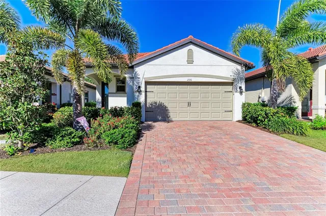 a kitchen with a table a refrigerator a cabinets and stools