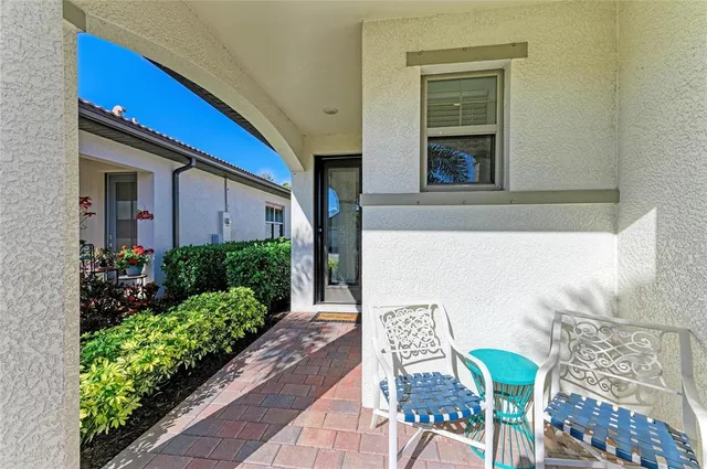 a large white kitchen with sink a refrigerator a stove and a dining table with wooden floor