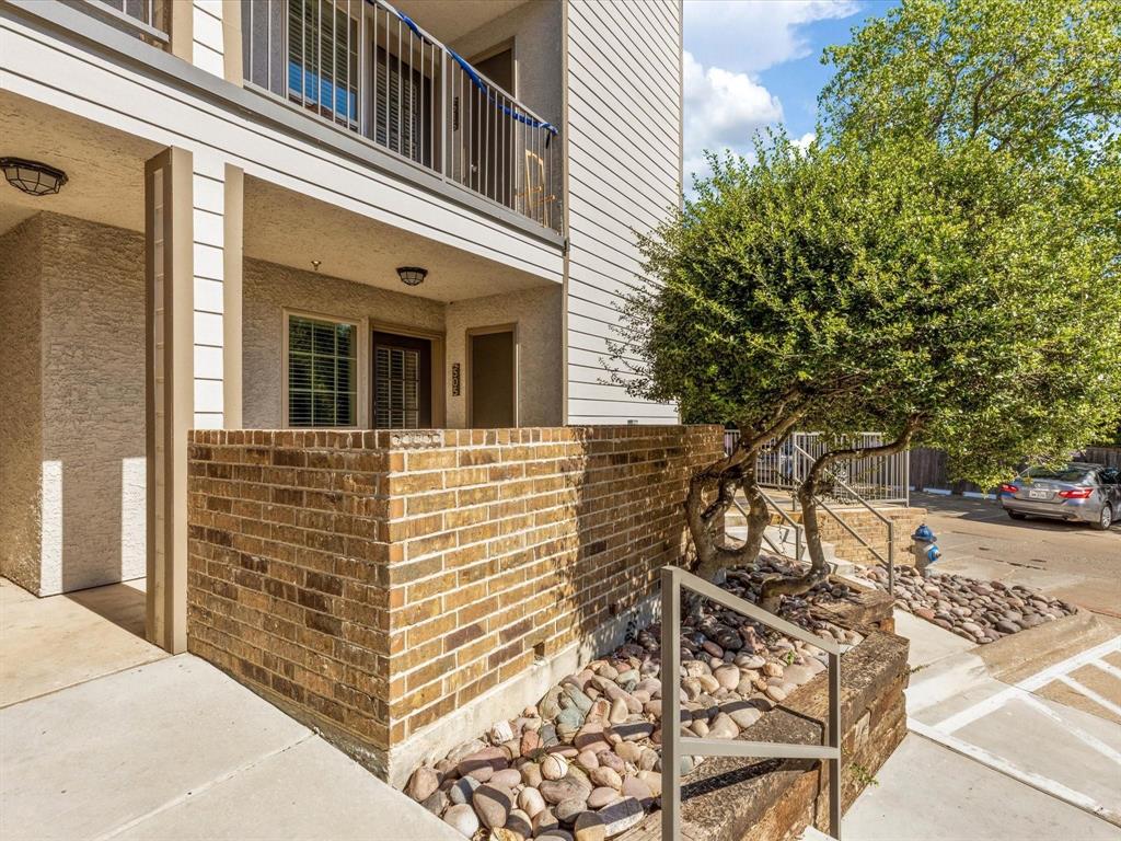 a front view of a house with large trees