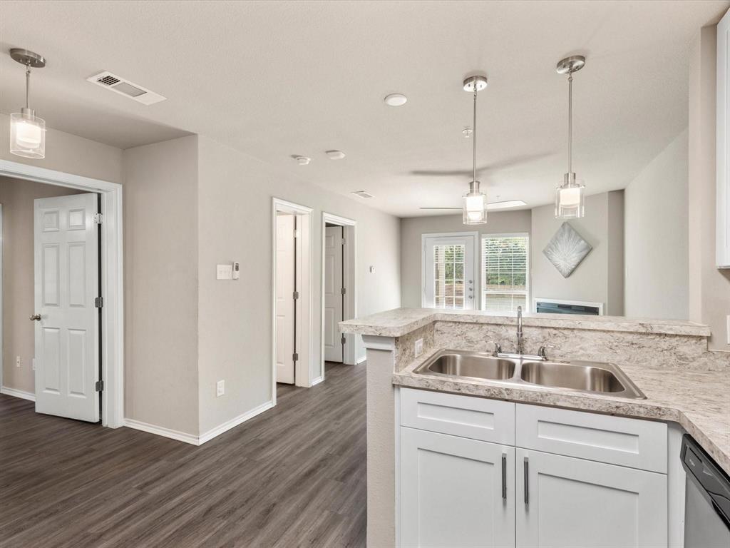 6108 Abrams Road, Unit 505 Dallas, TX 75231 - Photo 12 of 20 a kitchen with a sink a counter space and wooden floor