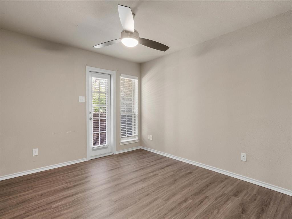 6108 Abrams Road, Unit 505 Dallas, TX 75231 - Photo 13 of 20 a view of an empty room with wooden floor and a window