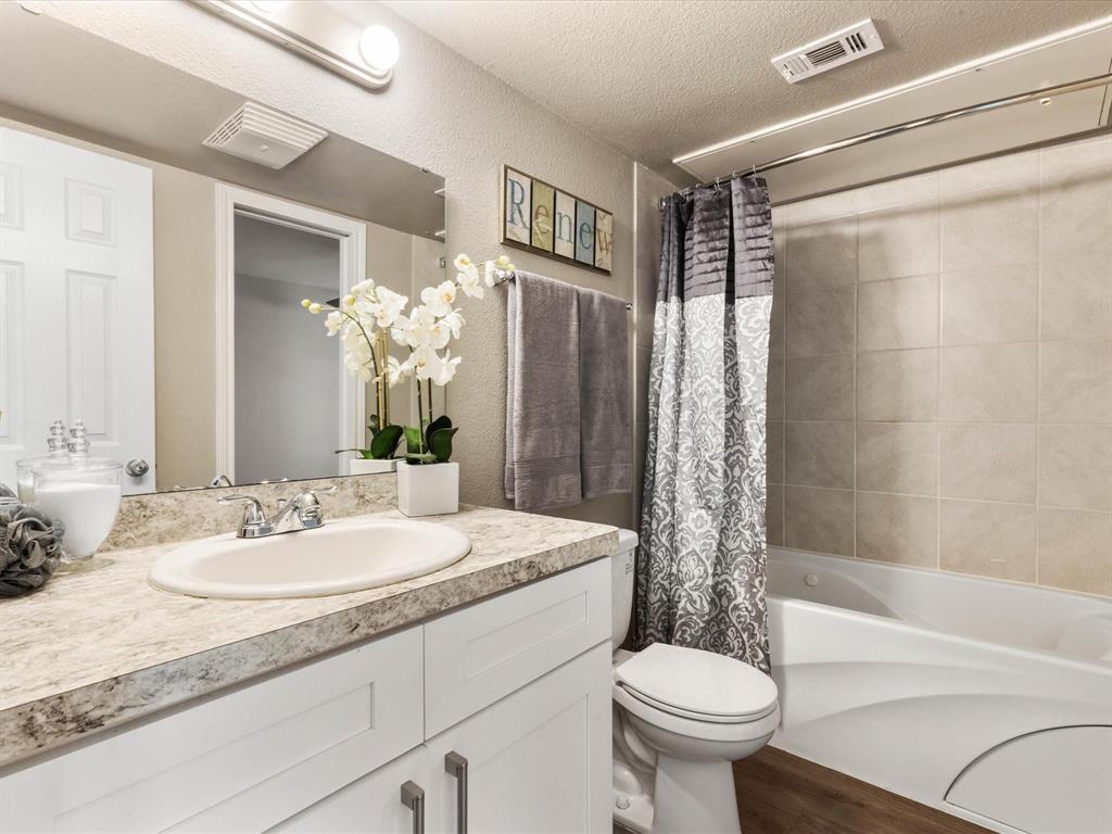 6108 Abrams Road, Unit 505 Dallas, TX 75231 - Photo 15 of 20 a bathroom with a granite countertop sink toilet and shower