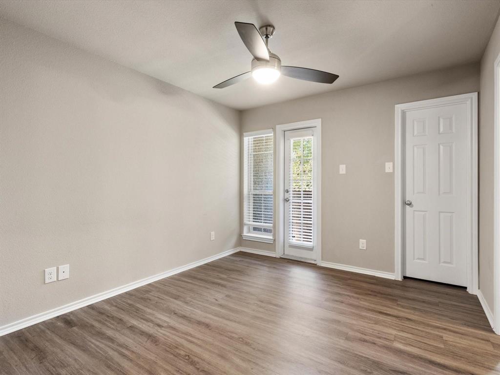6108 Abrams Road, Unit 505 Dallas, TX 75231 - Photo 16 of 20 an empty room with wooden floor and windows