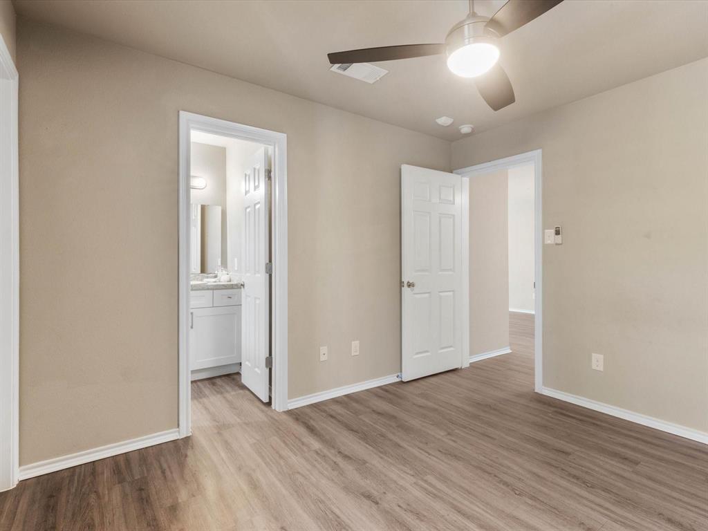 6108 Abrams Road, Unit 505 Dallas, TX 75231 - Photo 17 of 20 an empty room with wooden floor and windows