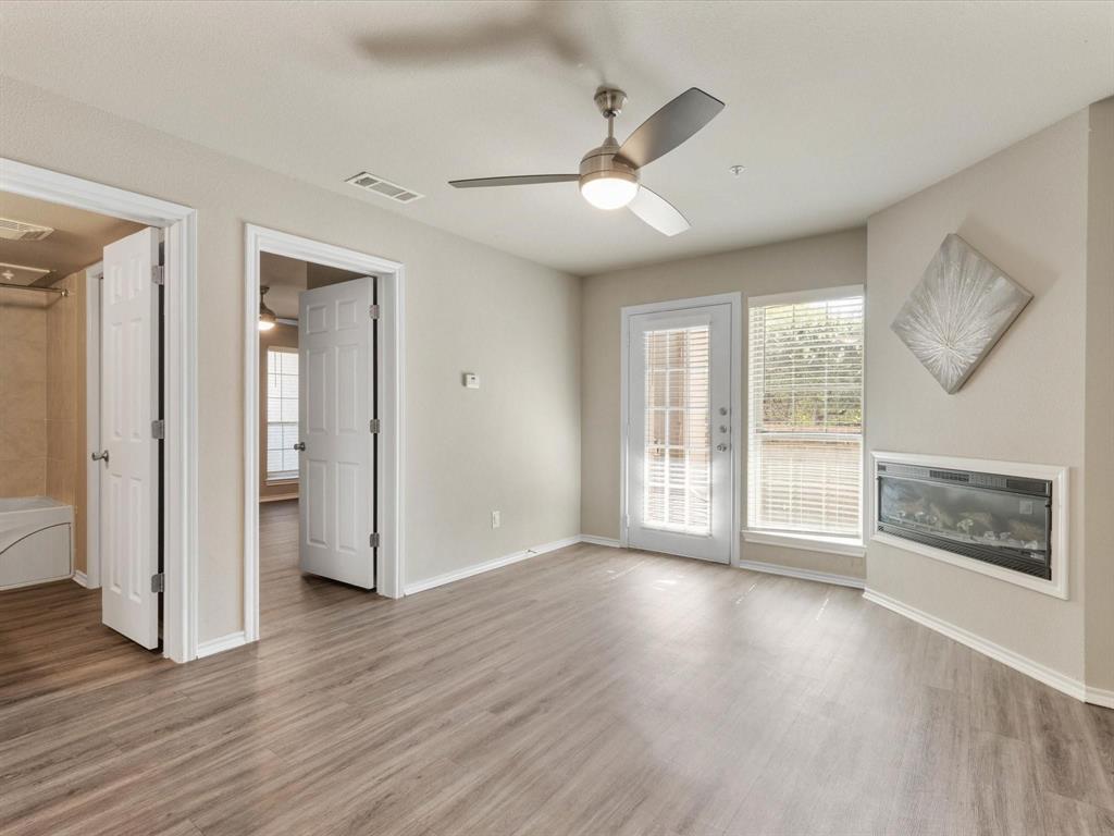 6108 Abrams Road, Unit 505 Dallas, TX 75231 - Photo 6 of 20 a view of an empty room with a window and wooden floor