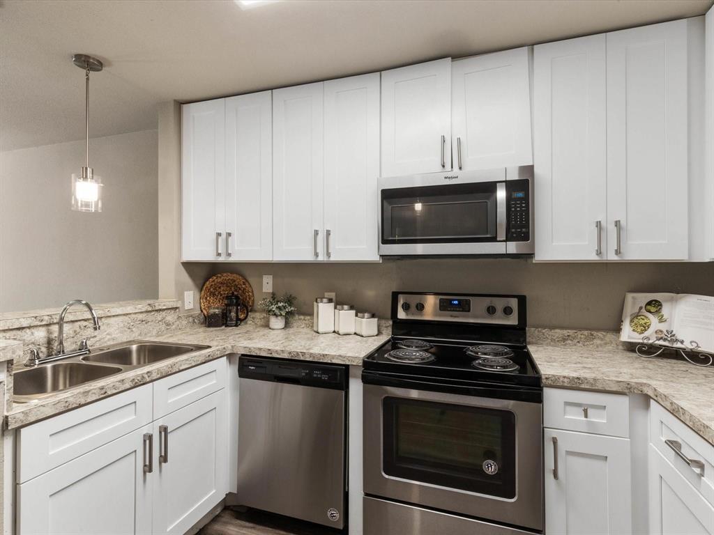 6108 Abrams Road, Unit 505 Dallas, TX 75231 - Photo 10 of 20 a kitchen with a sink stove and microwave
