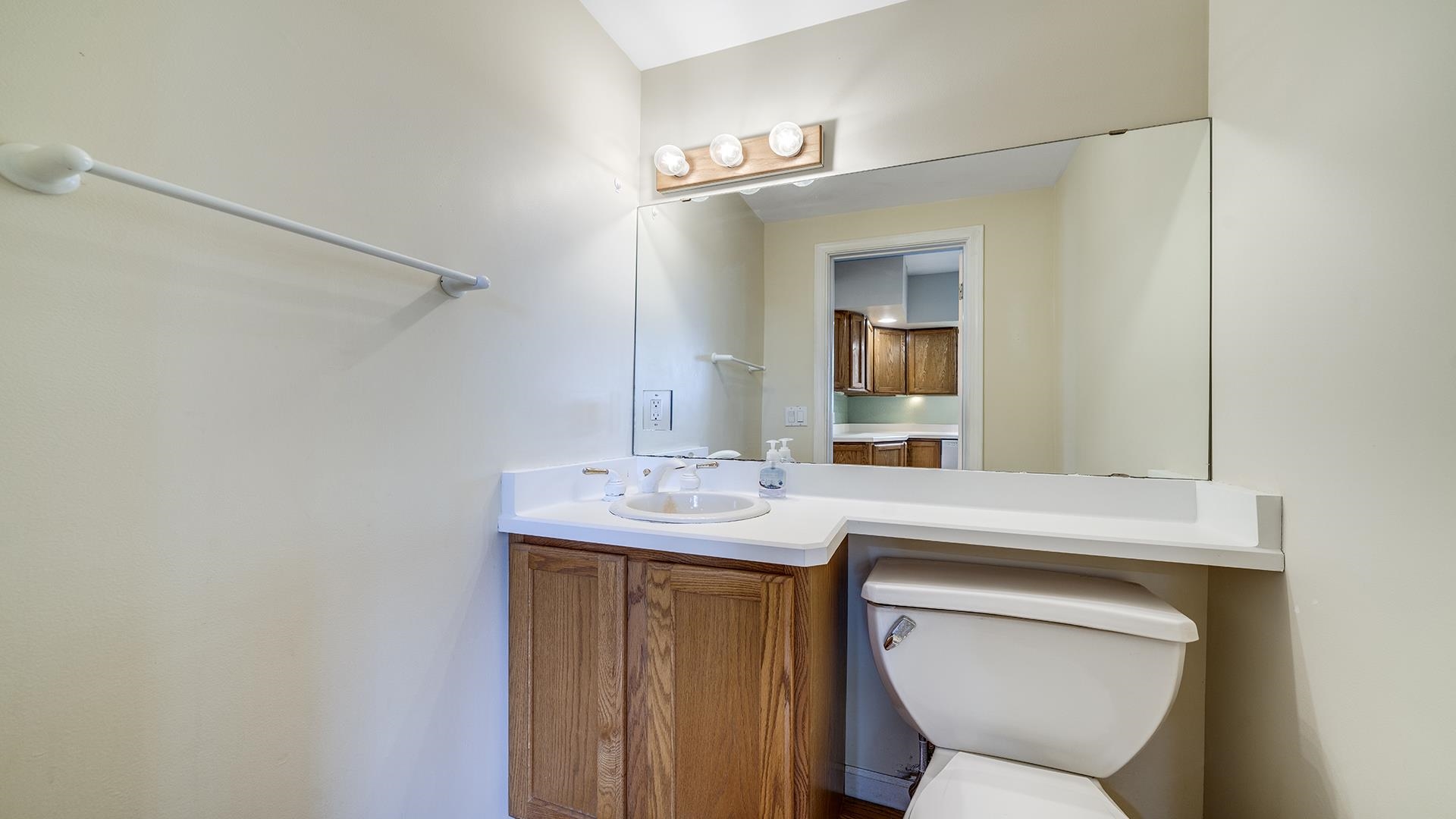 9020 East Flagg Road Rochelle, IL 61068 - Photo 15 of 61 a bathroom with a toilet sink and mirror