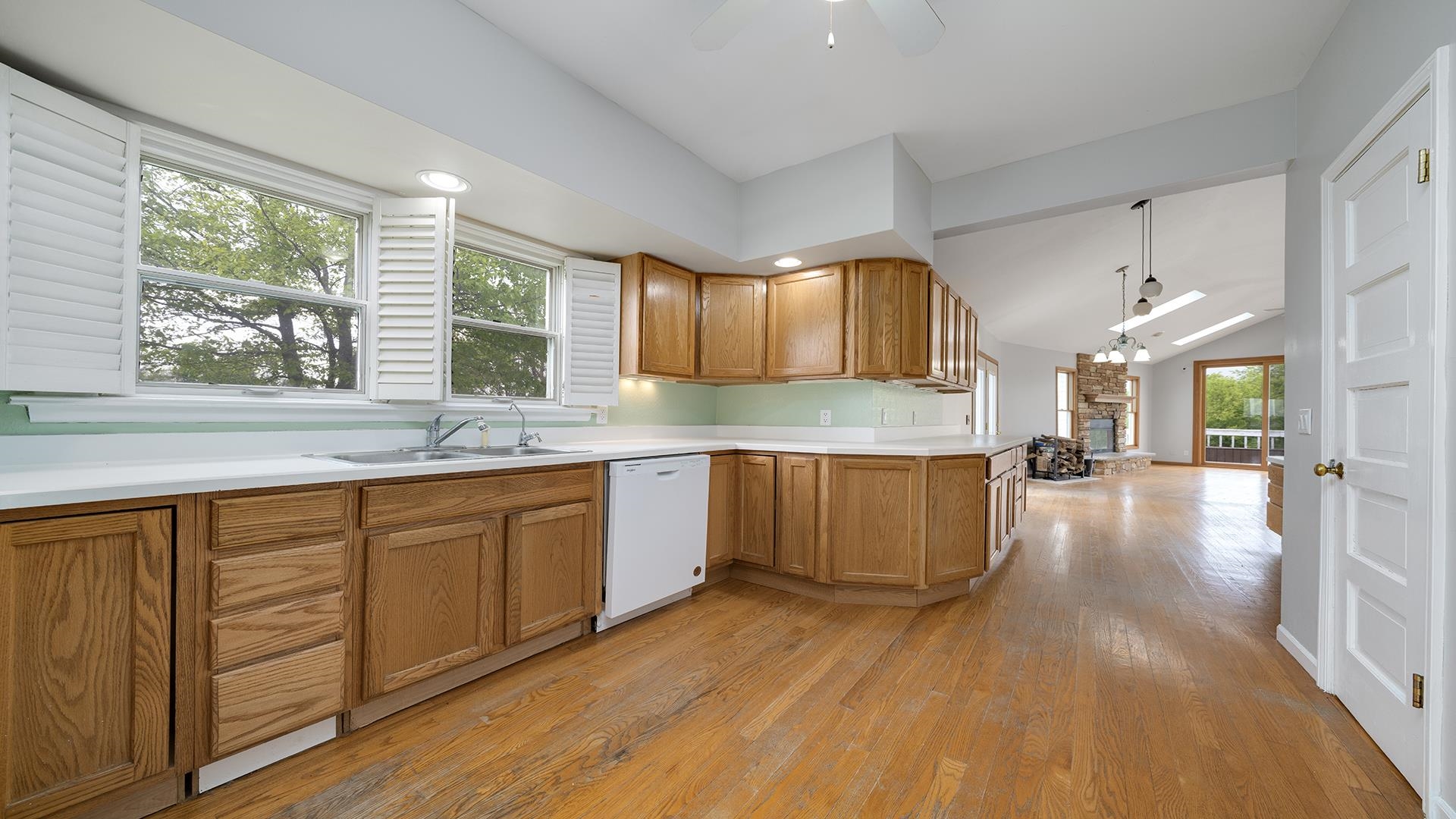 9020 East Flagg Road Rochelle, IL 61068 - Photo 18 of 61 a large kitchen with stainless steel appliances wooden floors and wooden cabinets