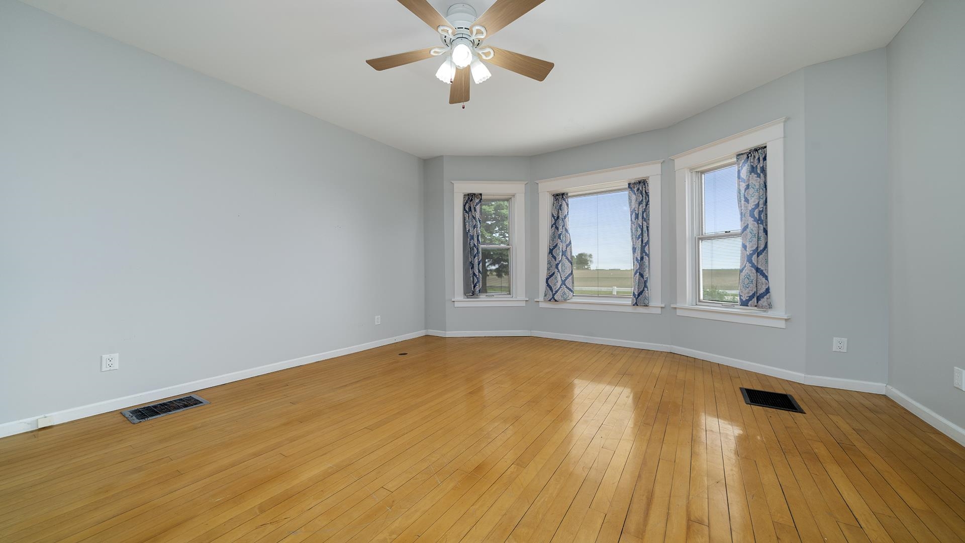 9020 East Flagg Road Rochelle, IL 61068 - Photo 21 of 61 a view of empty room with wooden floor and fan
