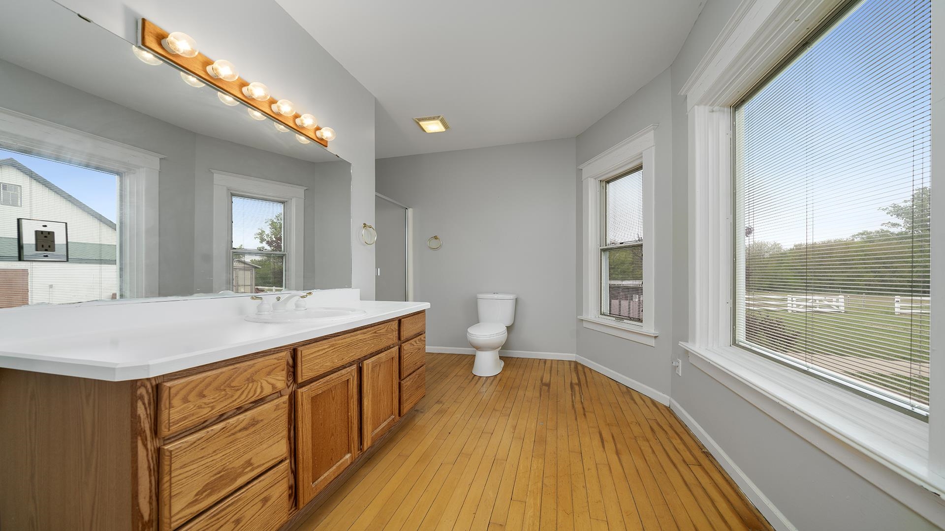 9020 East Flagg Road Rochelle, IL 61068 - Photo 24 of 61 a spacious bathroom with a granite countertop sink a large mirror a toilet and a shower