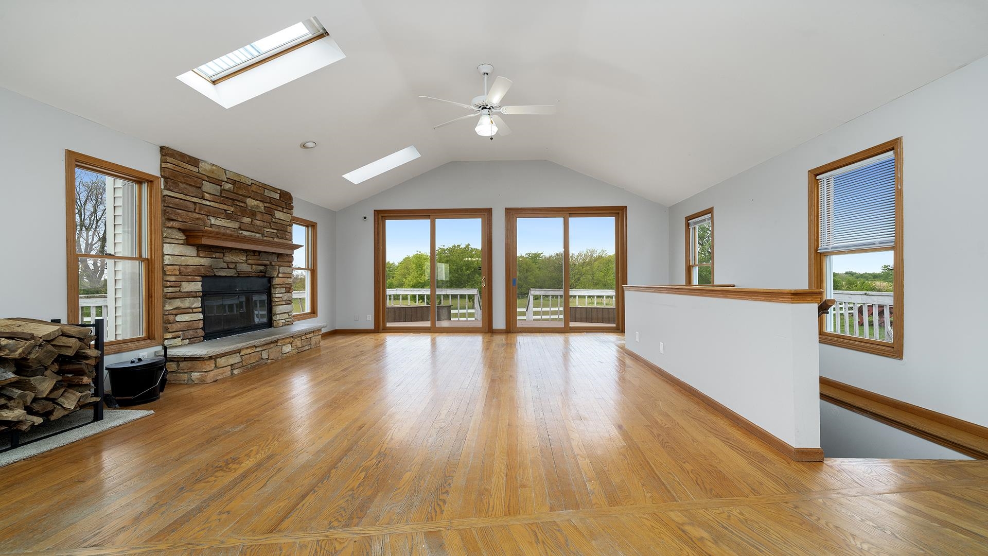 9020 East Flagg Road Rochelle, IL 61068 - Photo 5 of 61 a view of empty room with wooden floor and fireplace
