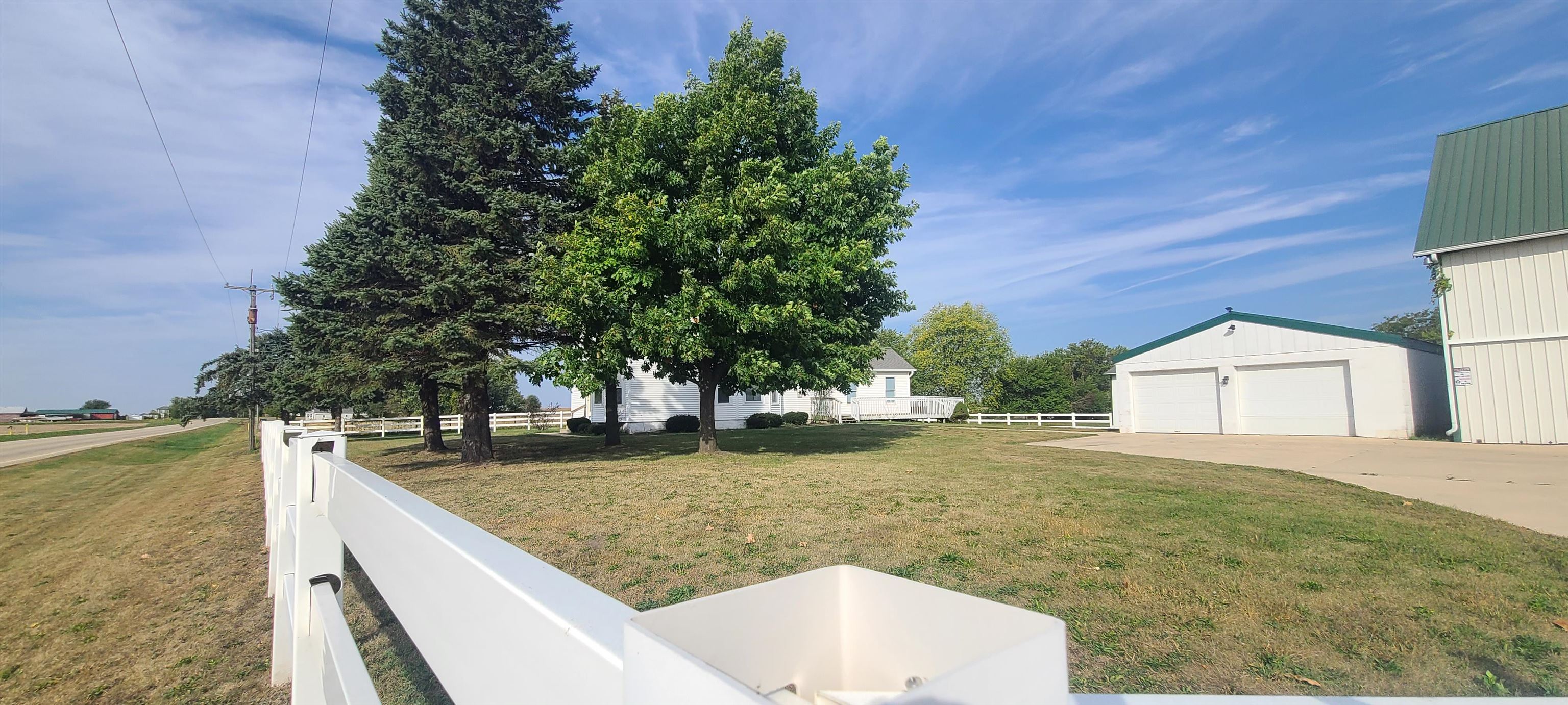 9020 East Flagg Road Rochelle, IL 61068 - Photo 53 of 61 a view of a backyard that has a tree on the side of the road