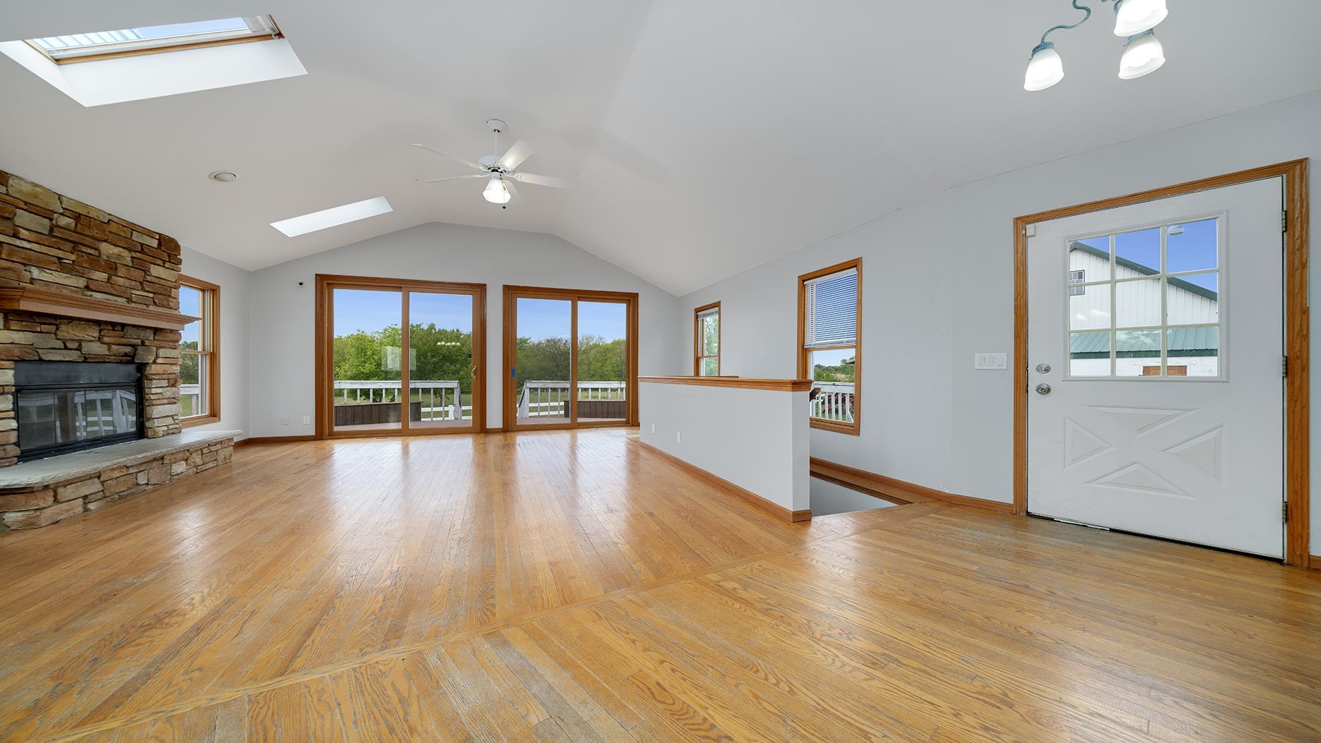 9020 East Flagg Road Rochelle, IL 61068 - Photo 6 of 61 a view of empty room with wooden floor and fireplace