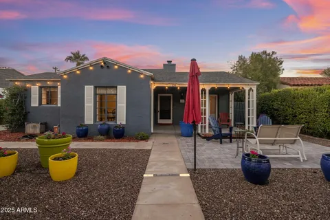 a view of a patio with couches table and chairs and potted plants
