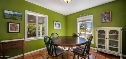 a dining room with furniture and a window