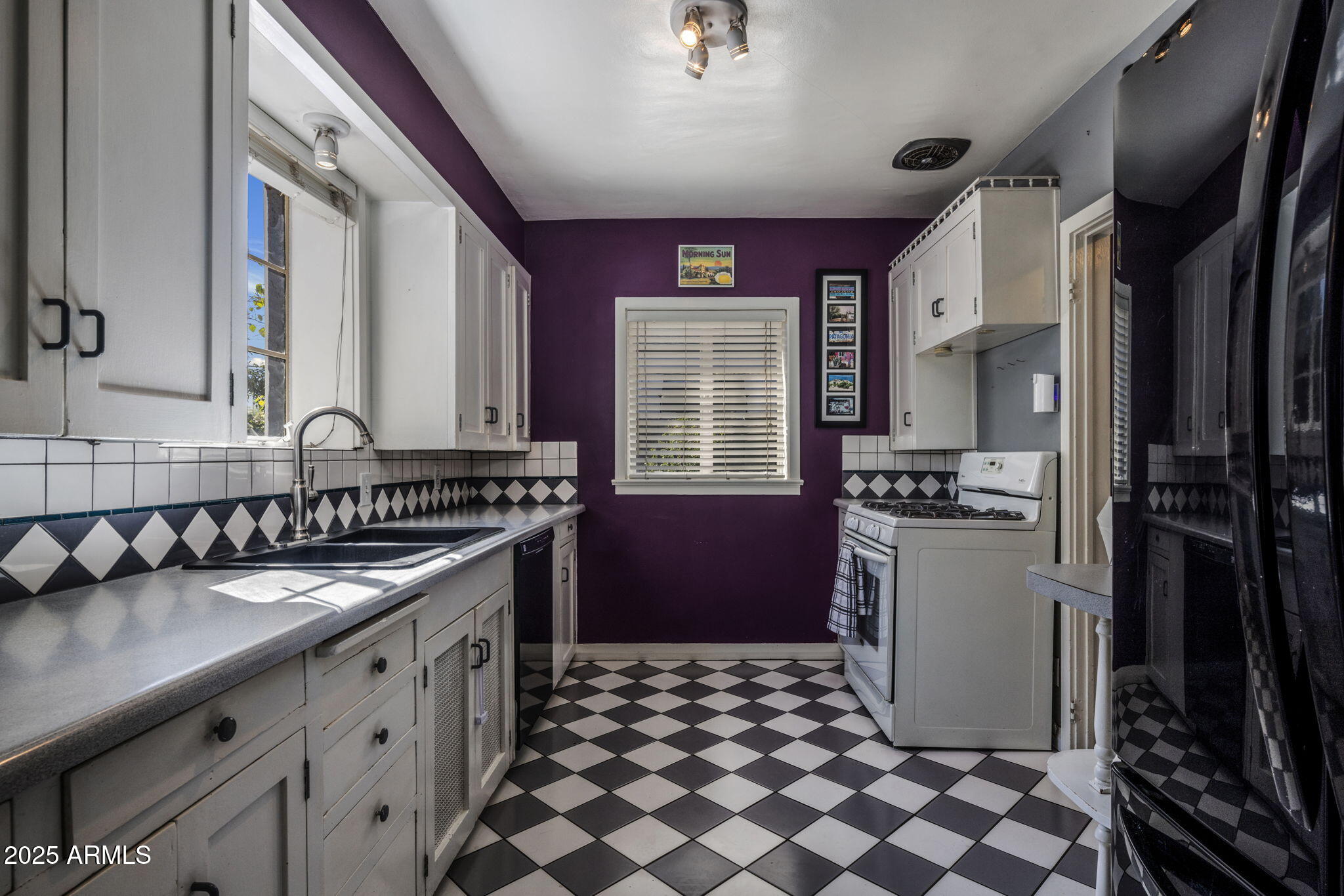 136 West Granada Road Phoenix, AZ 85003 - Photo 12 of 57 a kitchen with a sink a refrigerator and cabinets