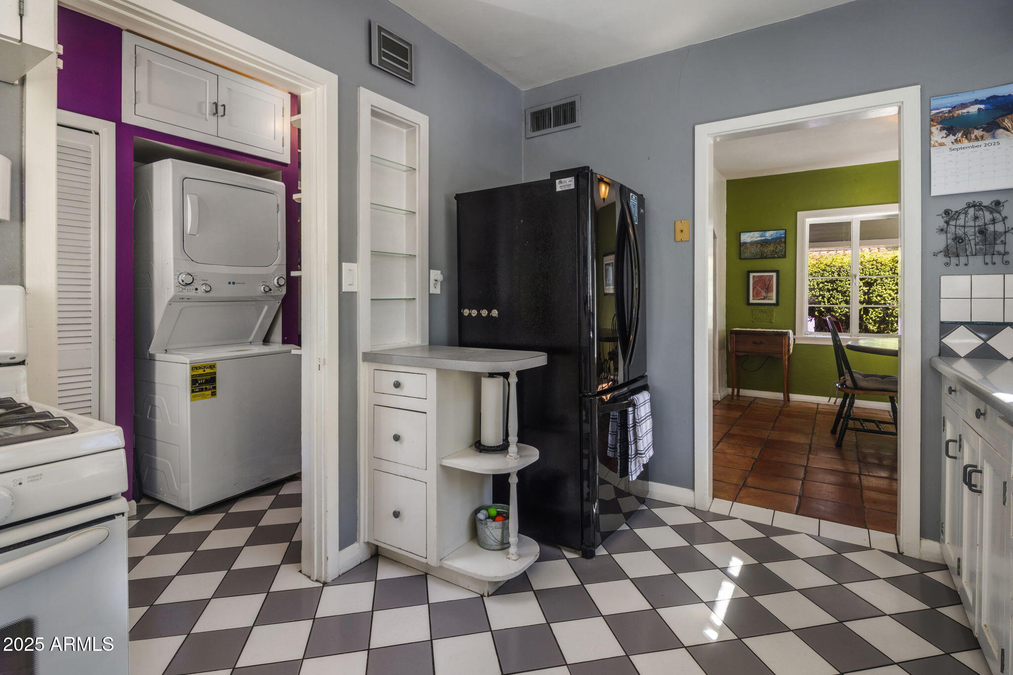 136 West Granada Road Phoenix, AZ 85003 - Photo 14 of 57 a room with a black white checkered floor with a dining table and a refrigerator