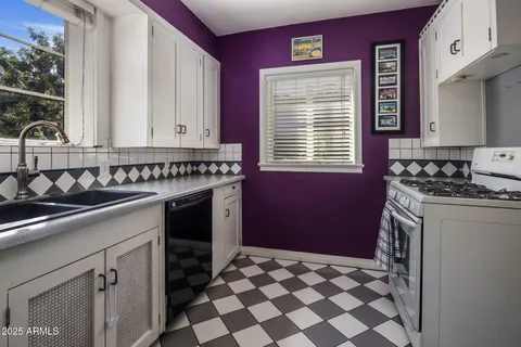 a kitchen with a stove a sink and a refrigerator
