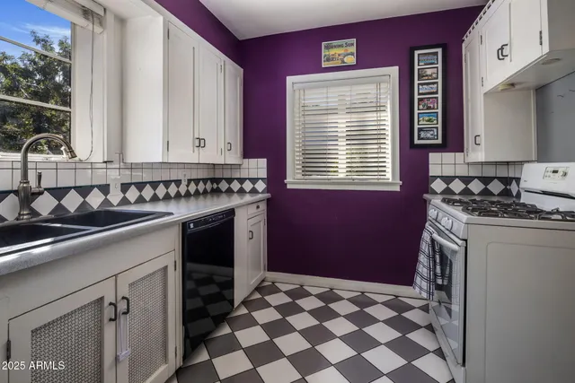 a kitchen with a stove a sink and a refrigerator