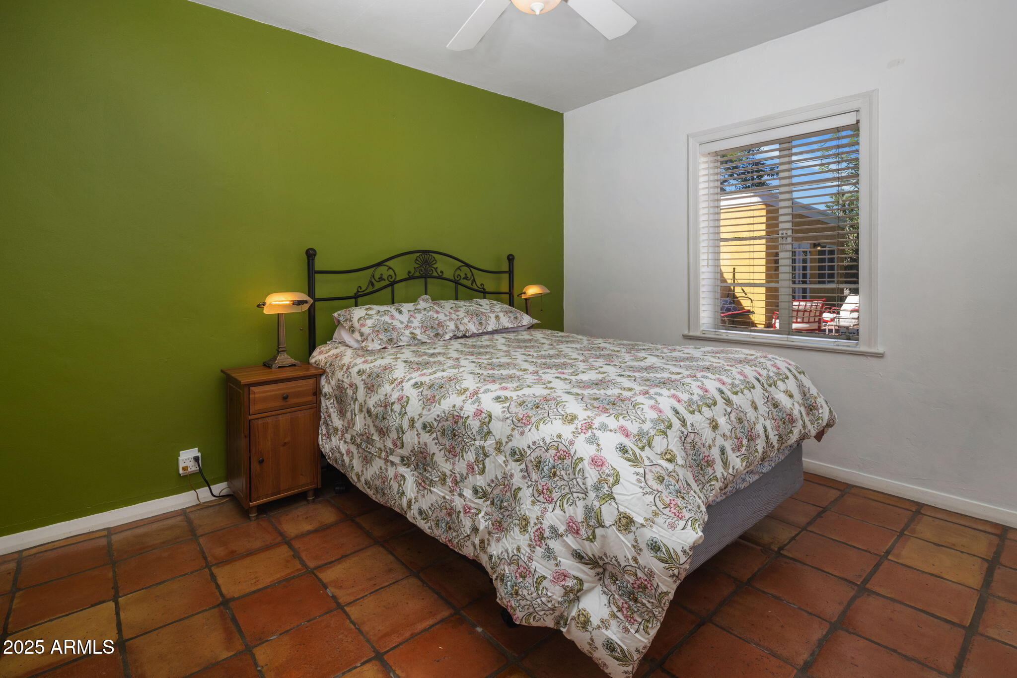 136 West Granada Road Phoenix, AZ 85003 - Photo 17 of 57 a bed sitting in a bedroom next to a window