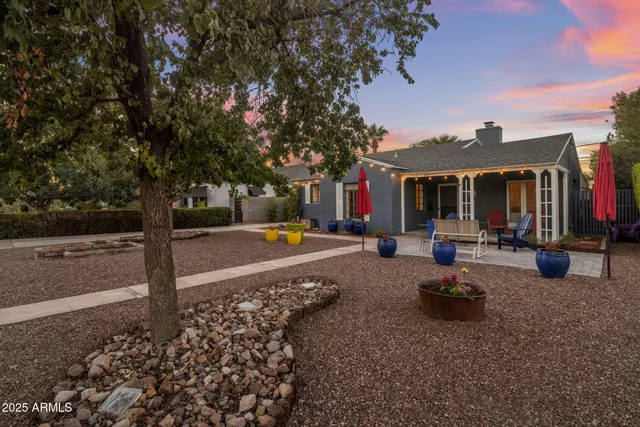 a view of a house with backyard porch and sitting area