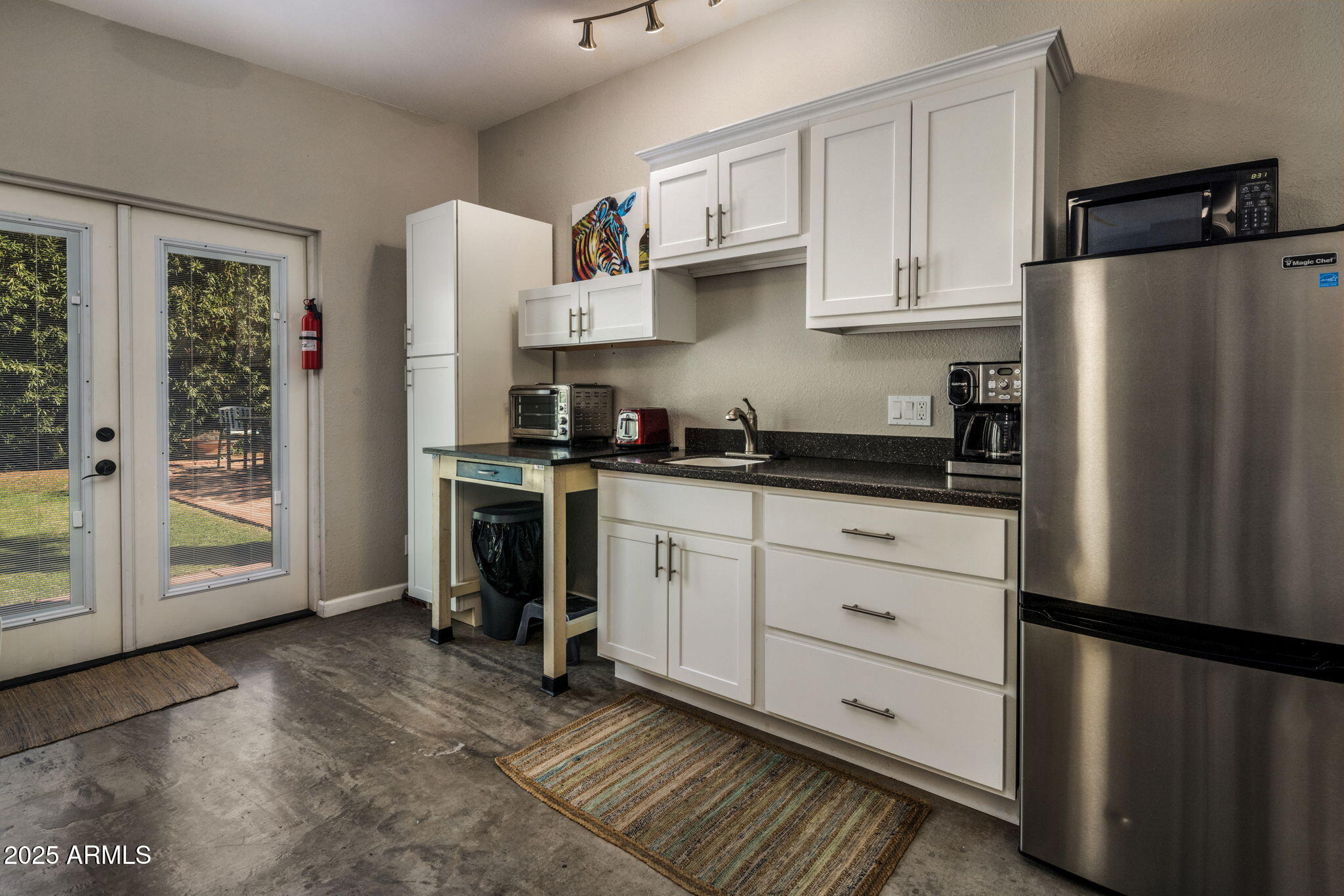 136 West Granada Road Phoenix, AZ 85003 - Photo 32 of 57 a kitchen with stainless steel appliances a refrigerator sink and cabinets