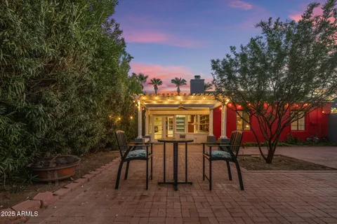 a view of a patio with table and chairs and potted plants
