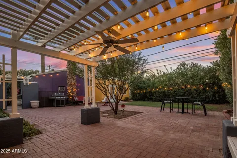 a view of a house with backyard and sitting area