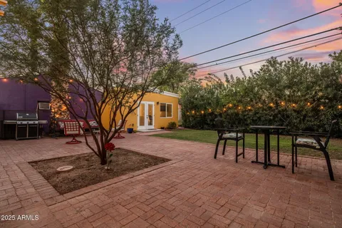 a man sitting on a bench in front of a house