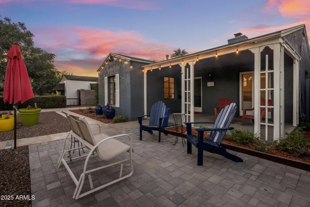 a view of a house with backyard porch and sitting area