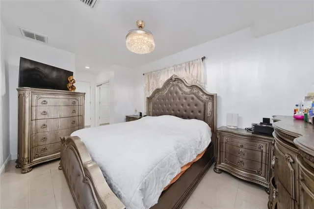 a bedroom with a bed and a television