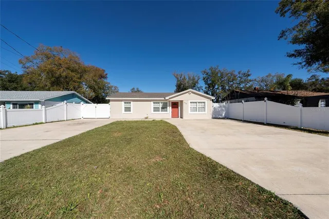 a view of white house with a yard
