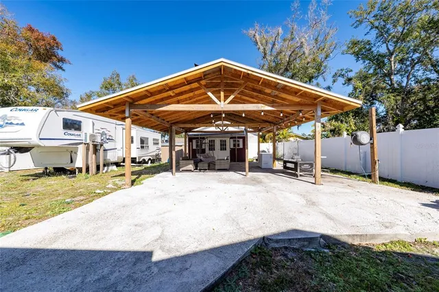 a view of a house with backyard and patio
