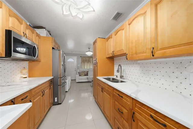 a kitchen with stainless steel appliances a sink a stove and a microwave