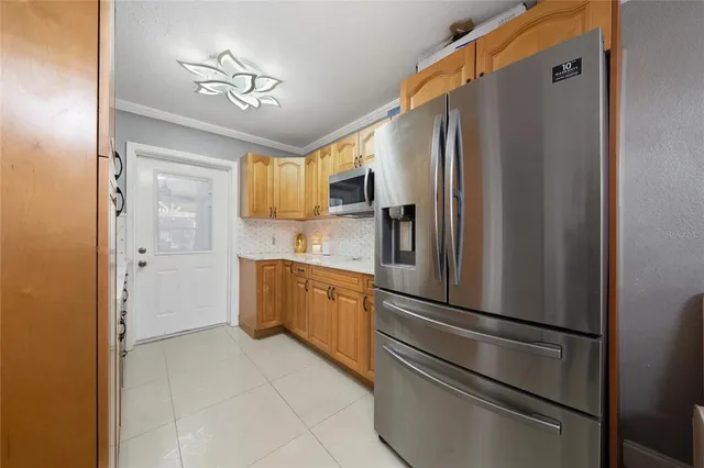 a kitchen with stainless steel appliances a refrigerator and cabinets