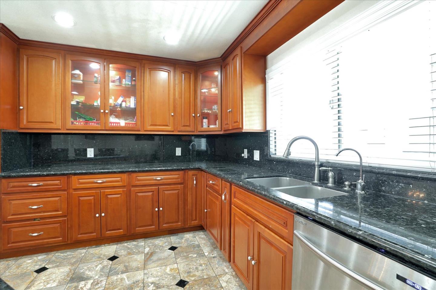 5450 Monterey Road, Unit 168 San Jose, CA 95111 - Photo 19 of 56 a large kitchen with granite countertop a sink and a wooden cabinets