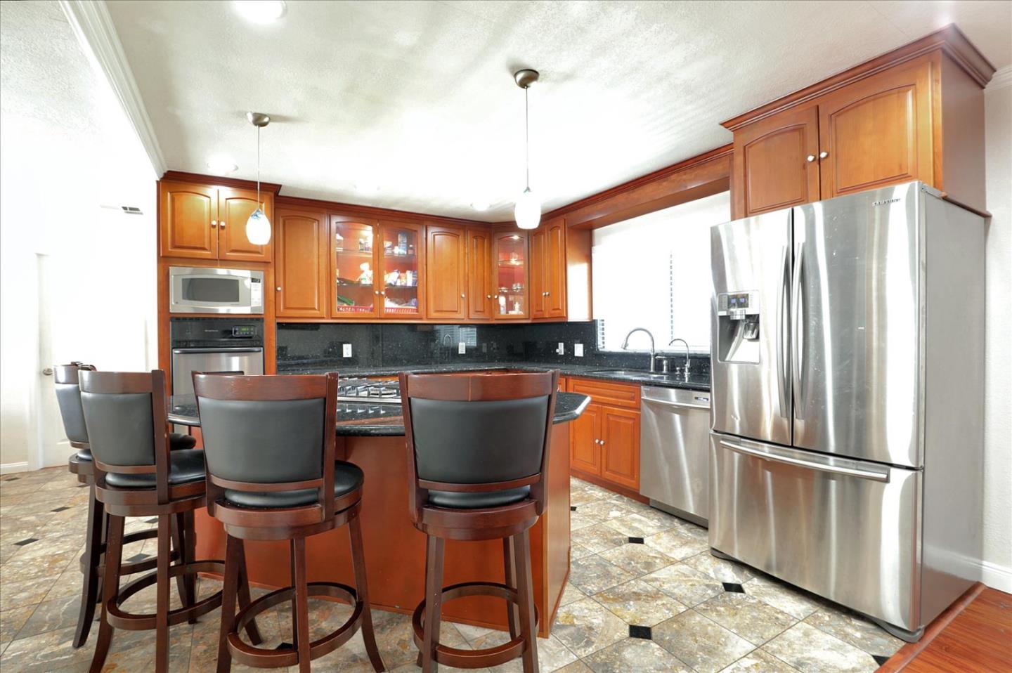 5450 Monterey Road, Unit 168 San Jose, CA 95111 - Photo 21 of 56 a kitchen with a table chairs refrigerator and window