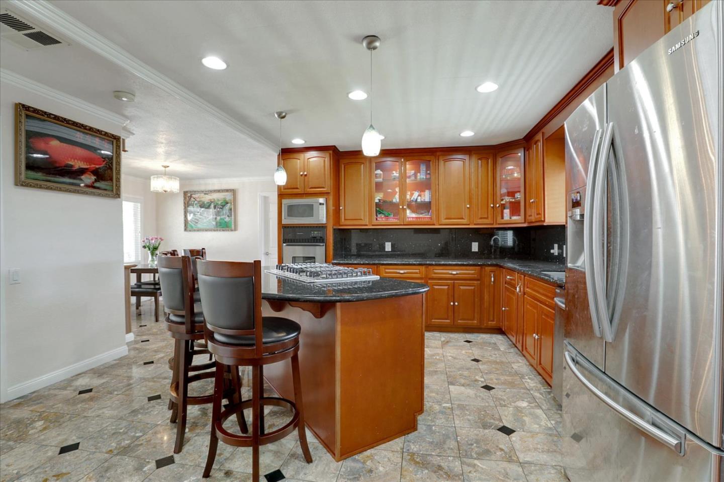 5450 Monterey Road, Unit 168 San Jose, CA 95111 - Photo 22 of 56 a kitchen with stainless steel appliances granite countertop a stove top oven a sink a refrigerator and chairs