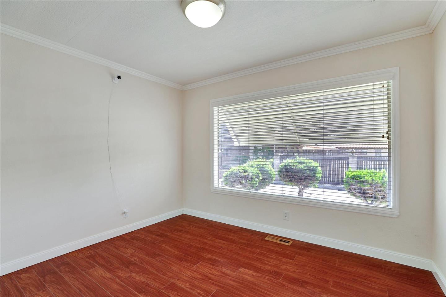 5450 Monterey Road, Unit 168 San Jose, CA 95111 - Photo 26 of 56 a view of an empty room with wooden floor and a window
