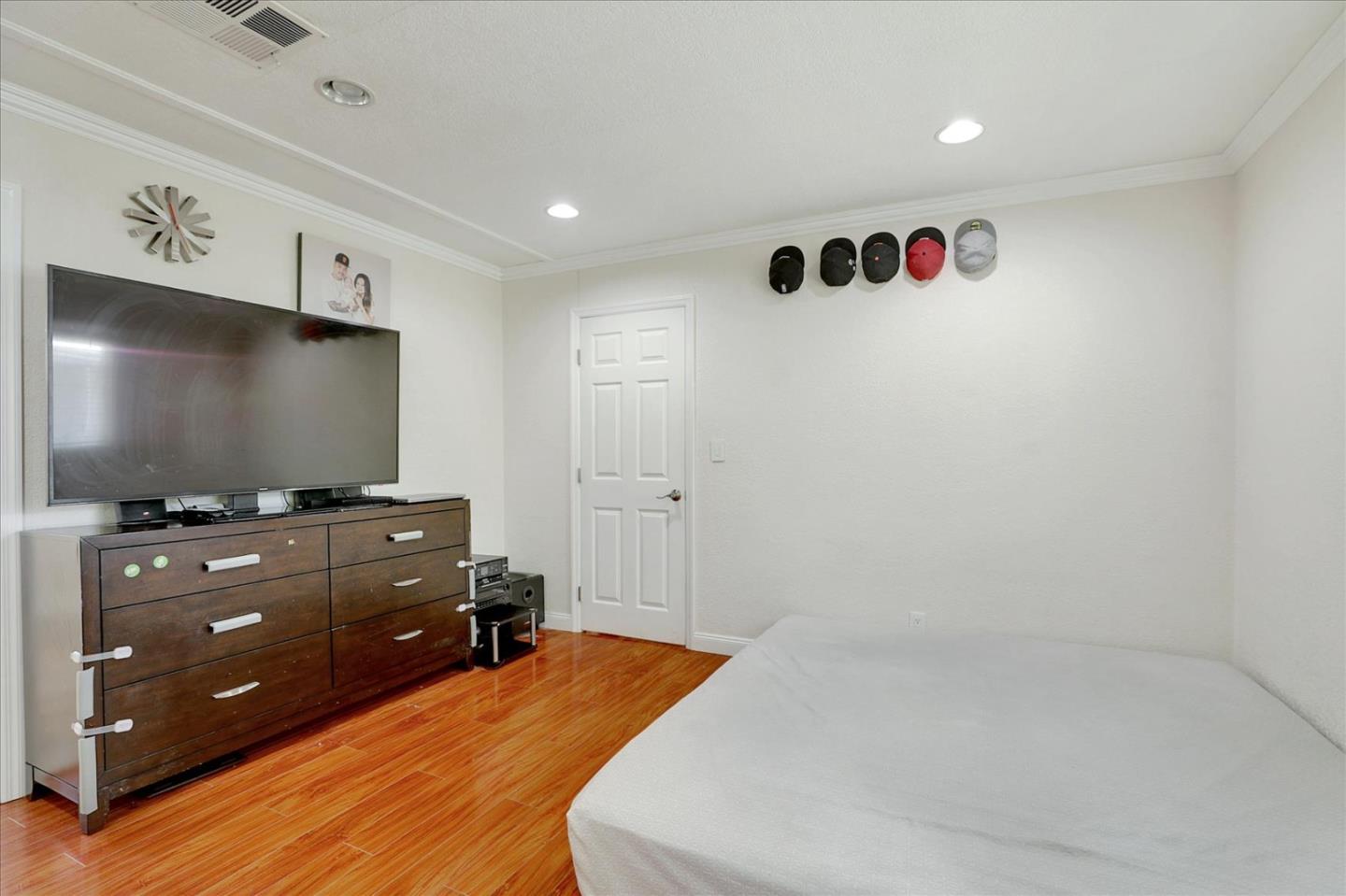 5450 Monterey Road, Unit 168 San Jose, CA 95111 - Photo 34 of 56 a bedroom with a bed and a flat tv screen on dresser