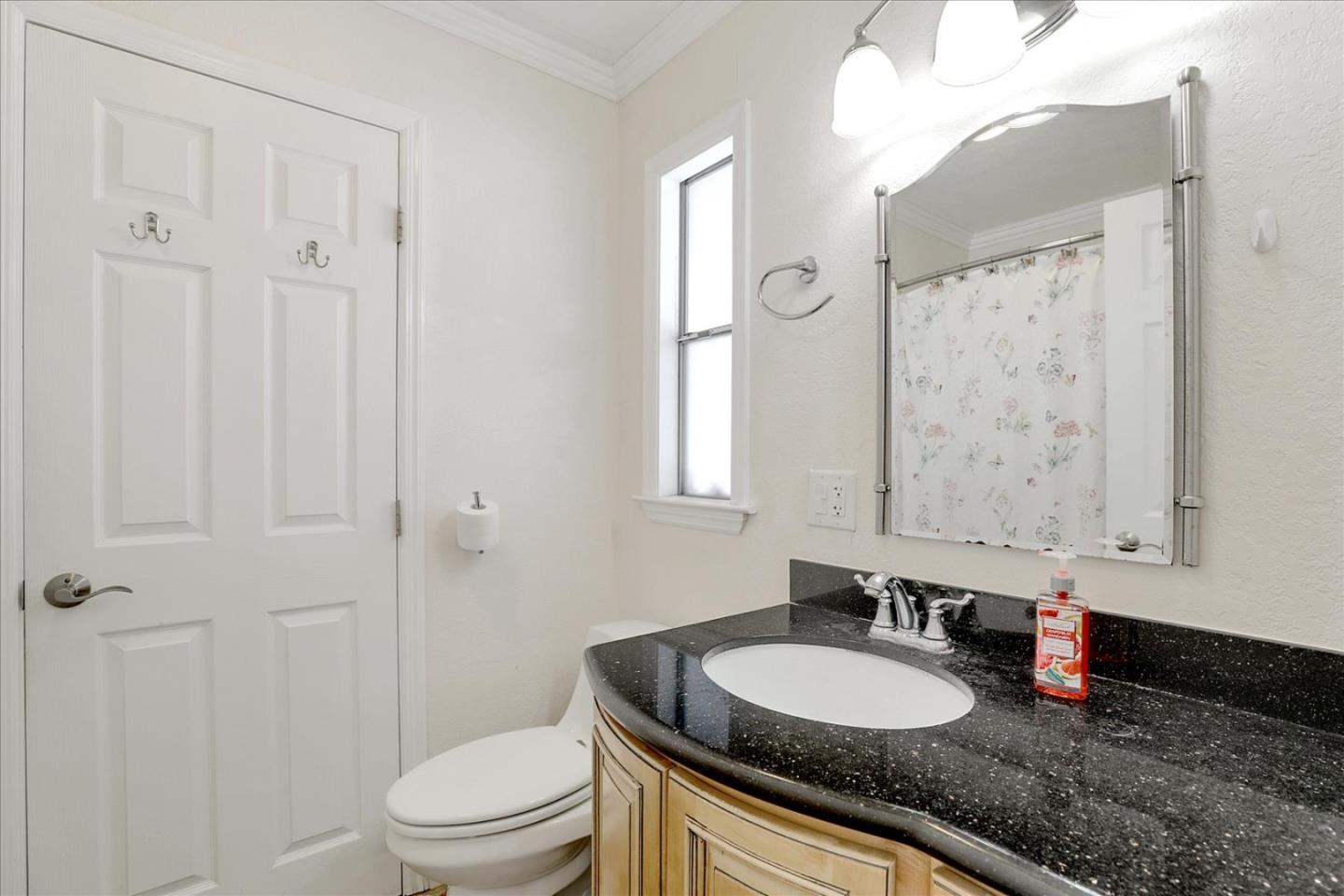 5450 Monterey Road, Unit 168 San Jose, CA 95111 - Photo 35 of 56 a bathroom with a granite countertop sink mirror vanity and toilet