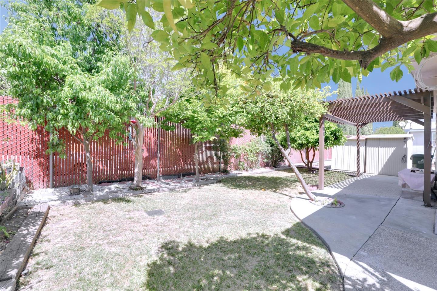 5450 Monterey Road, Unit 168 San Jose, CA 95111 - Photo 50 of 56 a patio with a table and chairs under an umbrella