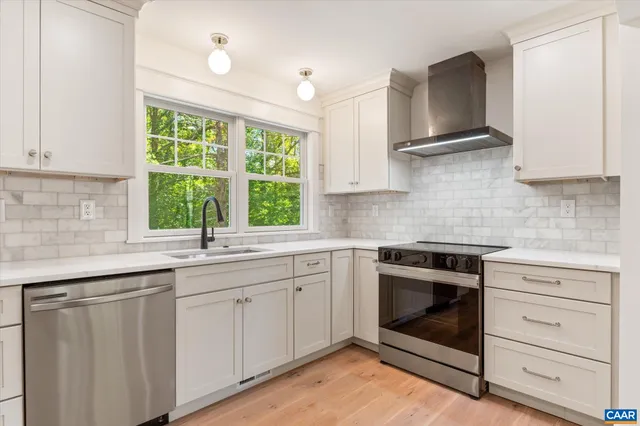 a kitchen with appliances cabinets and a window